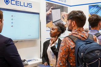 a woman presenting the celus platform to two man